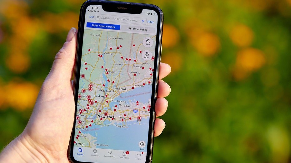 Zillow app on the phone in the hands of someone