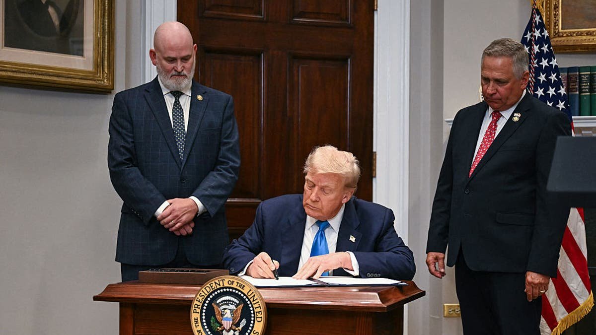 President Donald Trump signs the law reforming the VA domestic loan program in the Roosevelt room in the White House in Washington, July 30, 2025.