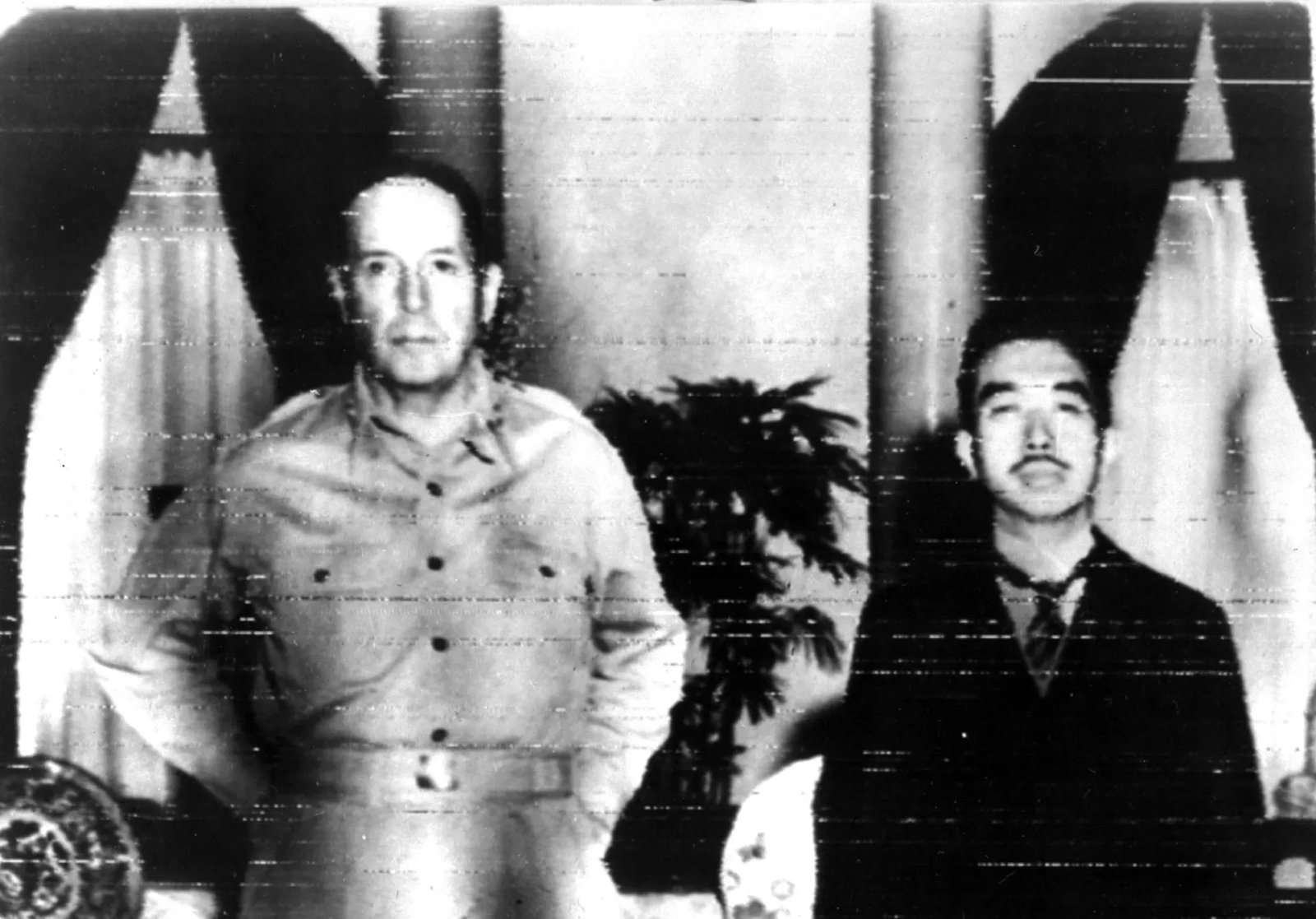 Two men sitting strongly and looking at the camera