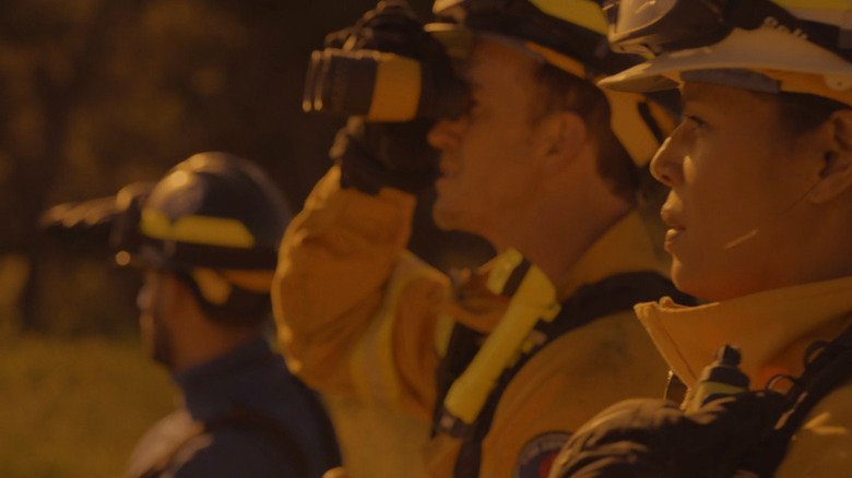 Firefighters watch the fire at Station 19