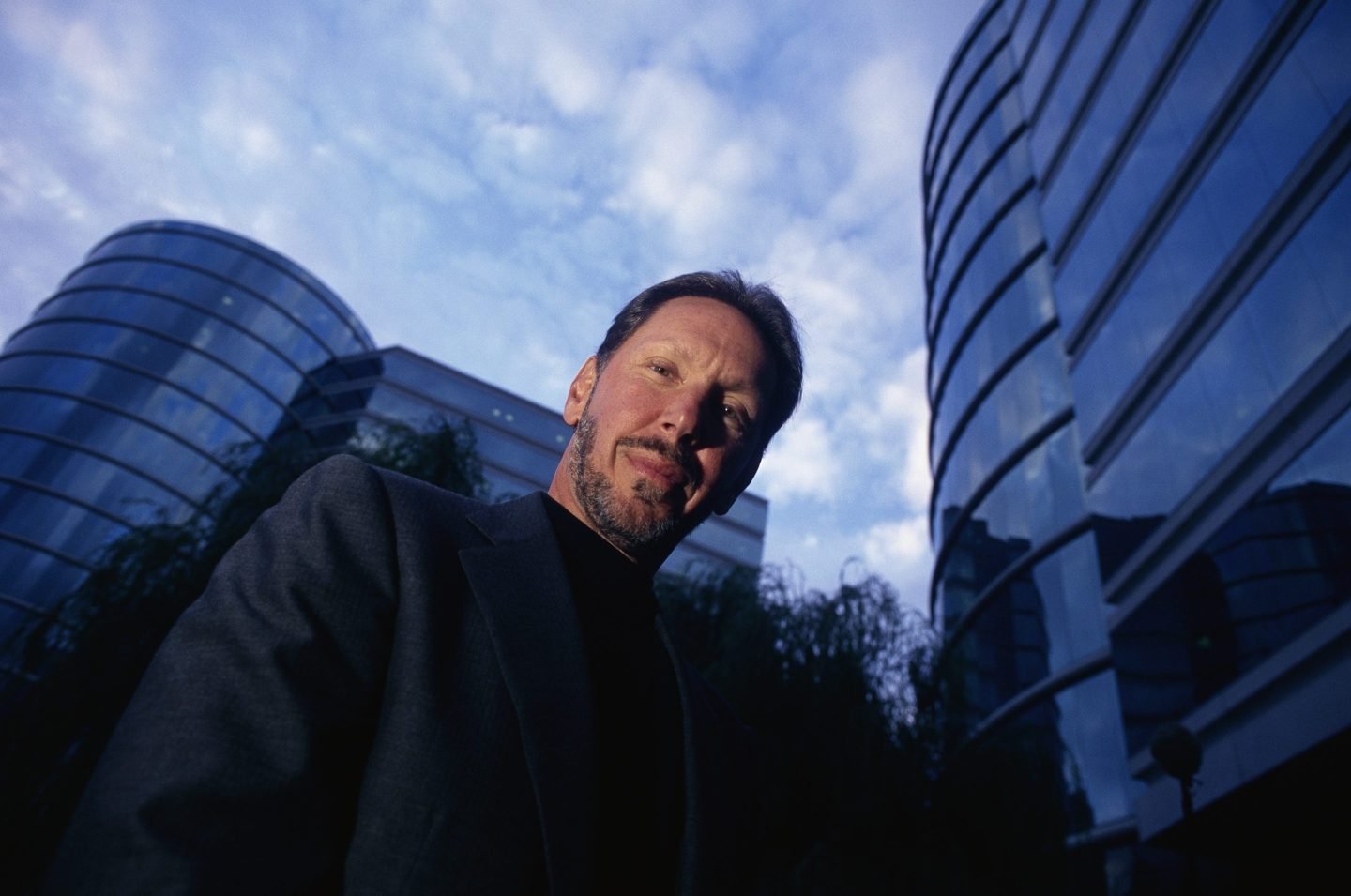 Larry Ellison with the buildings behind him