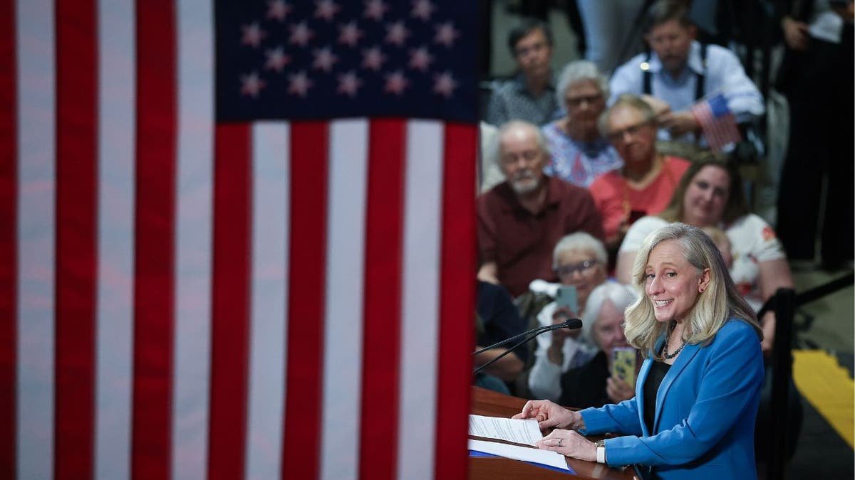 Spanberger on the right, the American flag dominates the image
