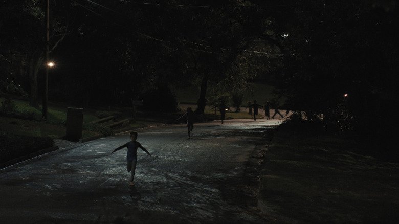 Children on the street running at night in weapons