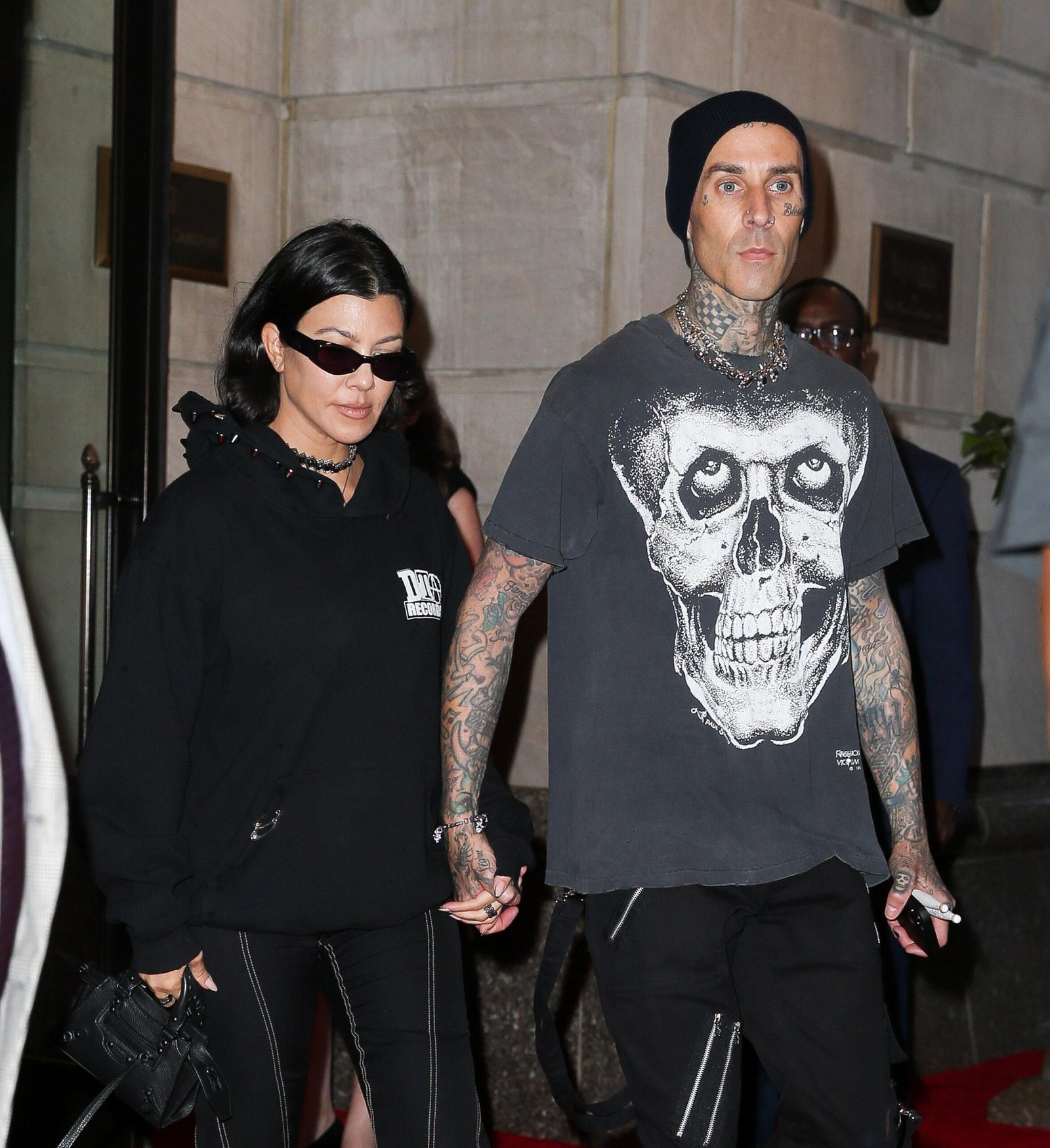 Kourtney Kardashian and Travis Barker saw alongside them as they were leaving their hotel in New York City