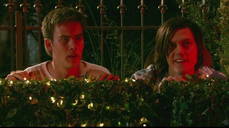 Eugene and Taker are hiding behind a bush in 