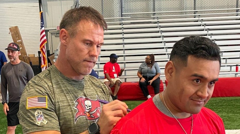 Mike Alstout signs a shirt