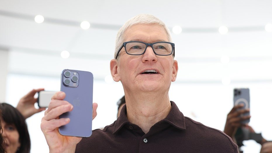 Tim Cook holds iPhone