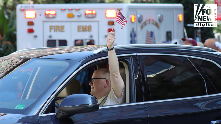 The protester holds the American flag in protest