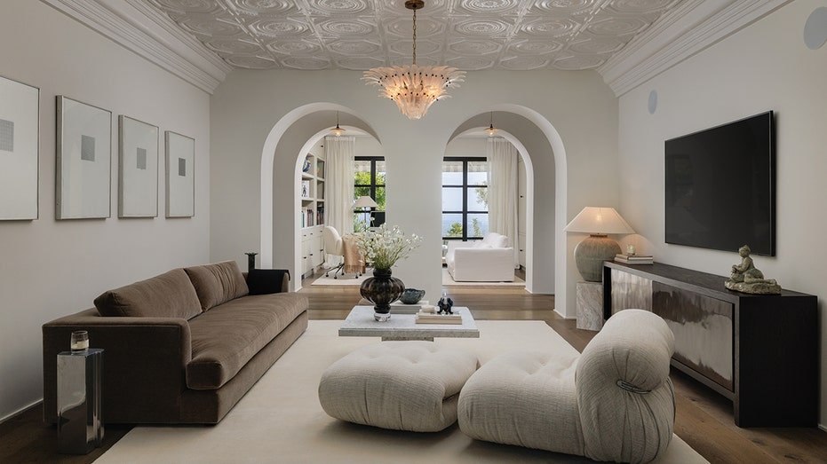 A living room is found with a TV elsewhere at home.