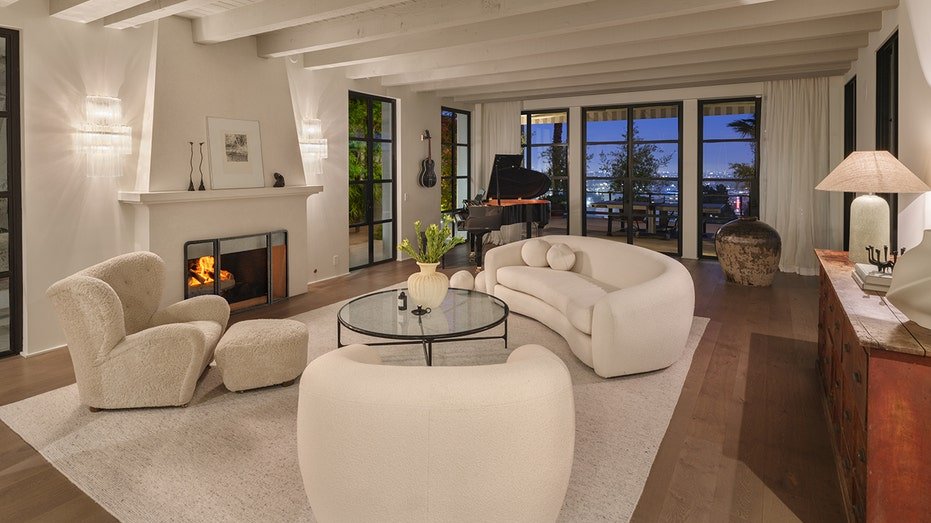 The living room features a fireplace located on firewood and reaching the backyard.