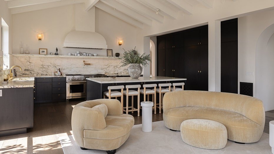 The kitchen features a large island for dining in a center.