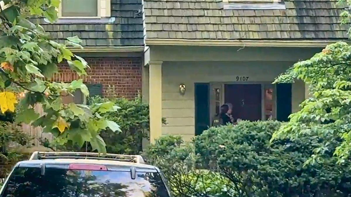 FBI agents outside Maryland's home for former National Security Adviser John Bolton on August 22, 2025.