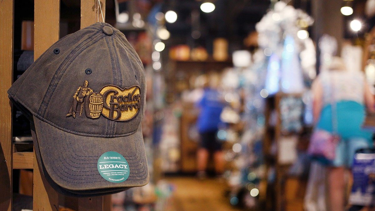 A hat display the old broken barrel logo shown inside a restaurant.