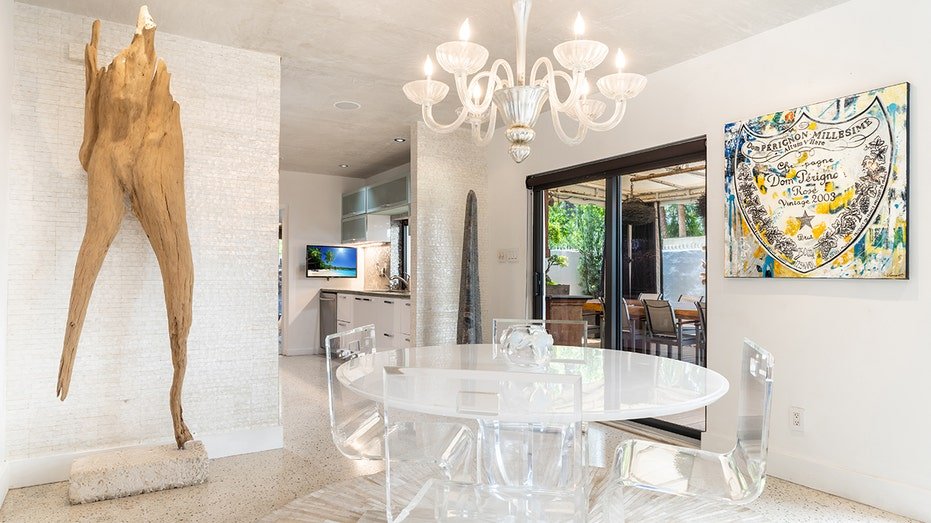 White table with white Chandaler over it