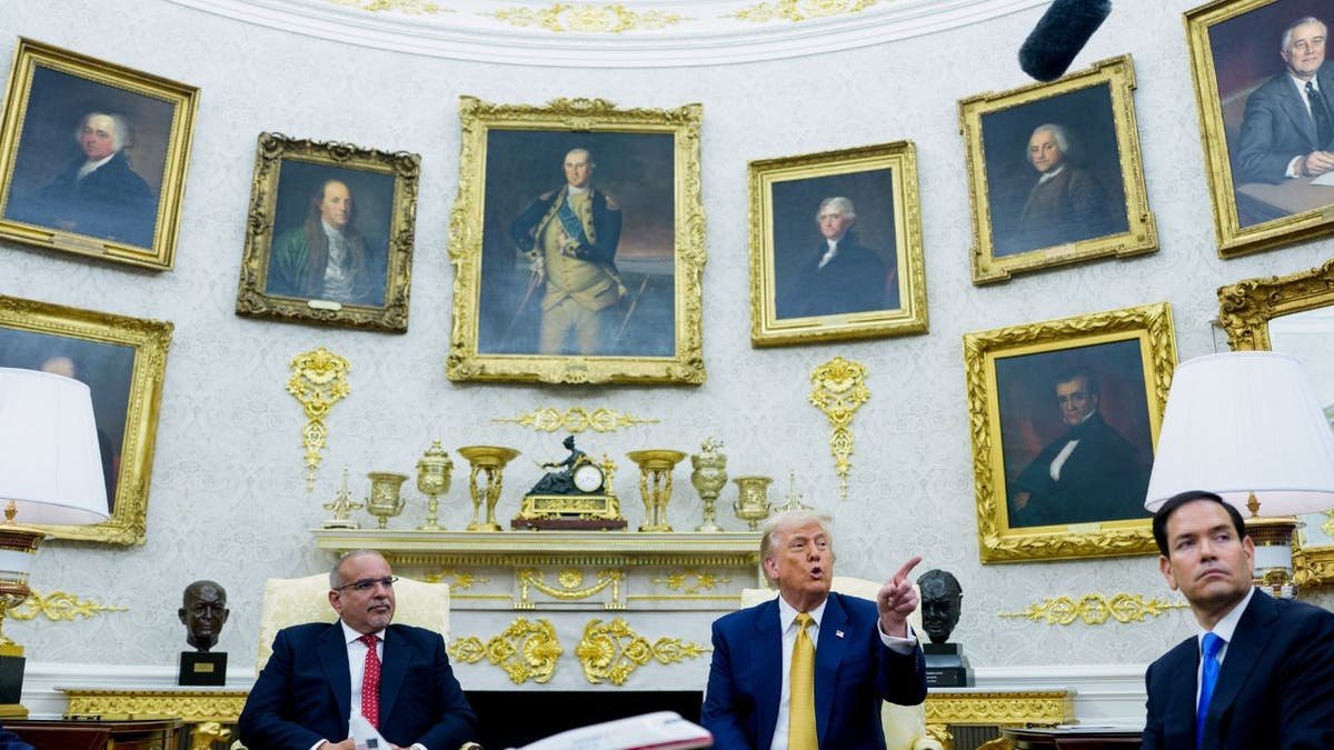 Trump speaks to a correspondent in the Oval Office