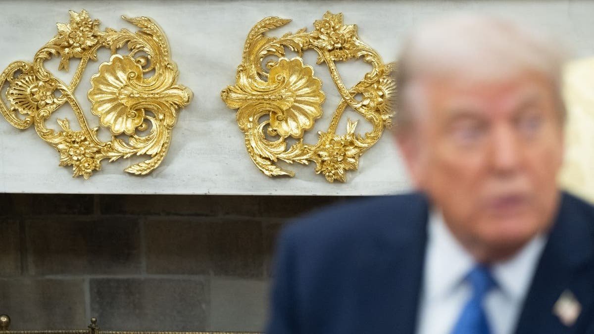 A close view of the golden details on the Trump fireplace in the Oval Office