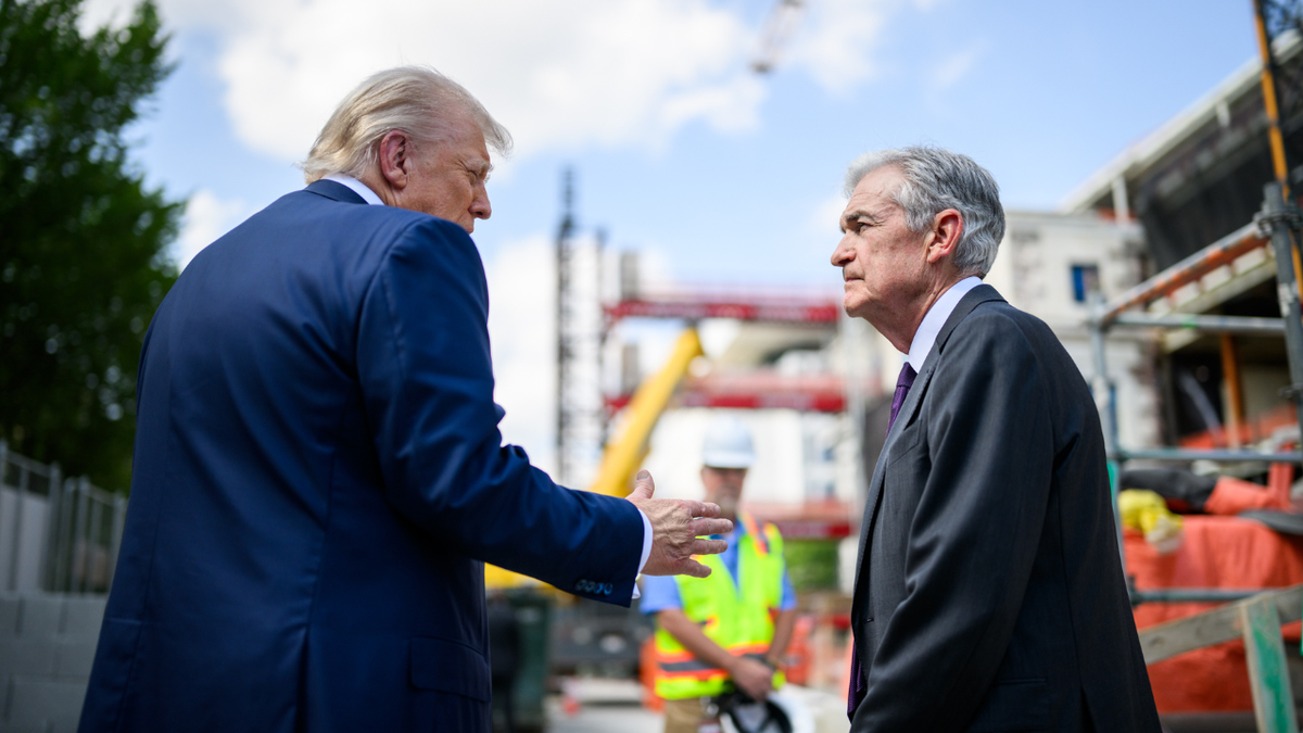 President Donald Trump speaks to the Federal Reserve Chairman Jerome Powell at the Federal Reserve Building site
