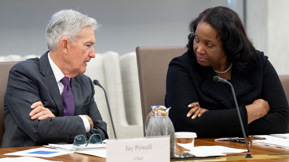 US Federal Reserve Chairman Jerome Powell talks to Lisa Cook