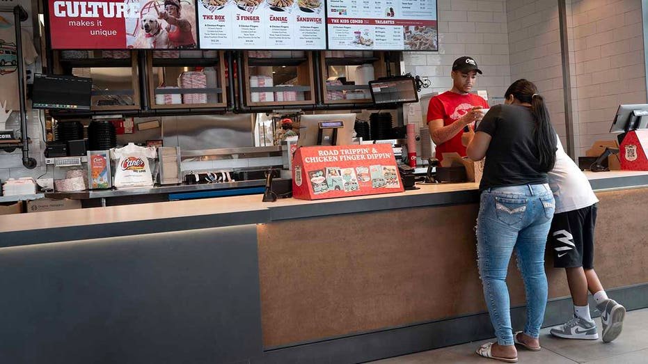 Customers submit a request at Raising Cane on June 30, 2025 in Chicago, Illinois.