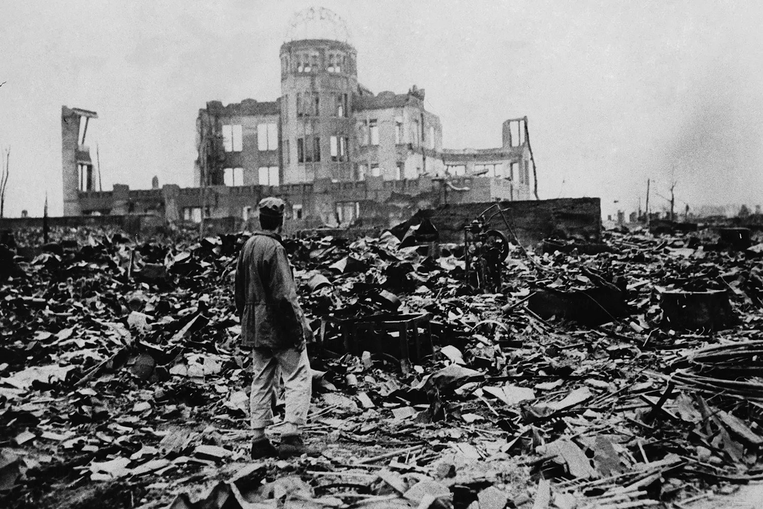 A man stands in the ruins of Hiroshima in Japan, after the United States dropped a atomic bomb on August 6, 1945. Jinbako's dome shell is the only remaining building.