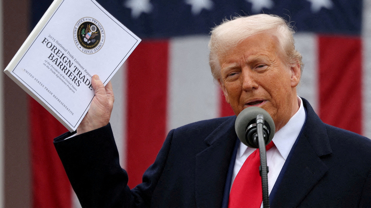 Trump holds a document of foreign trade barriers