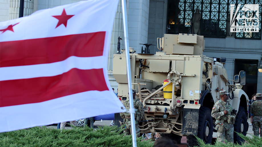 Capital flag flies in front of the National Guard