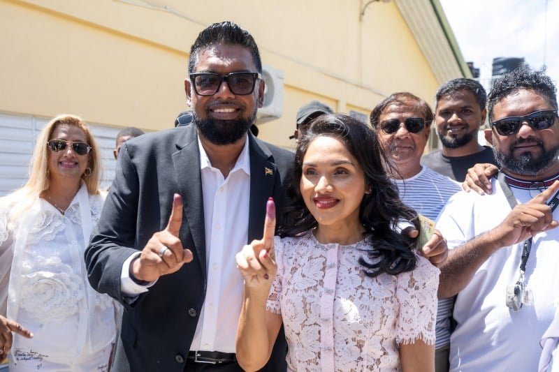 Joyanian president, Erfan Ali and his wife, Aria Ali, a gesture to the media after voting at a polling station during the general elections in Leonura, Guyana, on September 1.