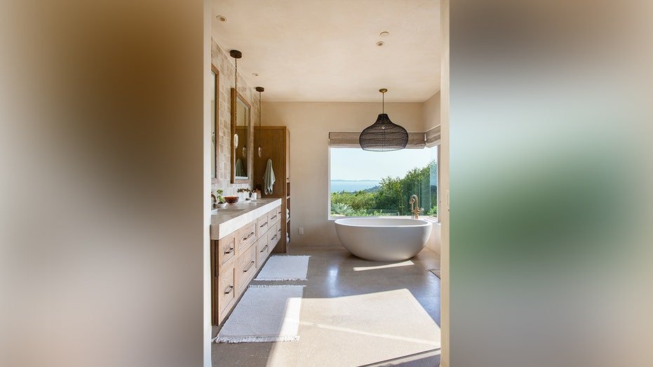 The inner bathroom includes long vanity as well as a valid basin.