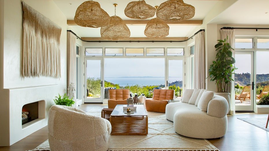 The living room is characterized by unique lighting fixtures and windows extending from floor to ceiling.