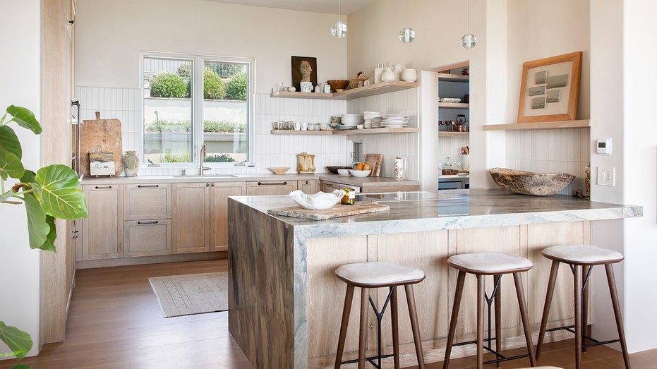 The kitchen features an island of dining and built -in shelves.