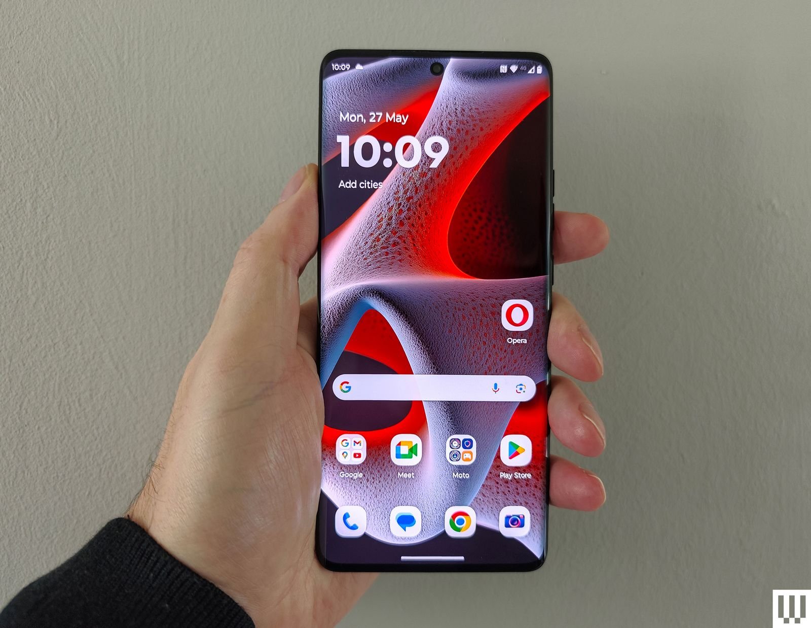 Handweds carry a slim laptop with round edges and screen that displays an abstract wallpaper and app icons