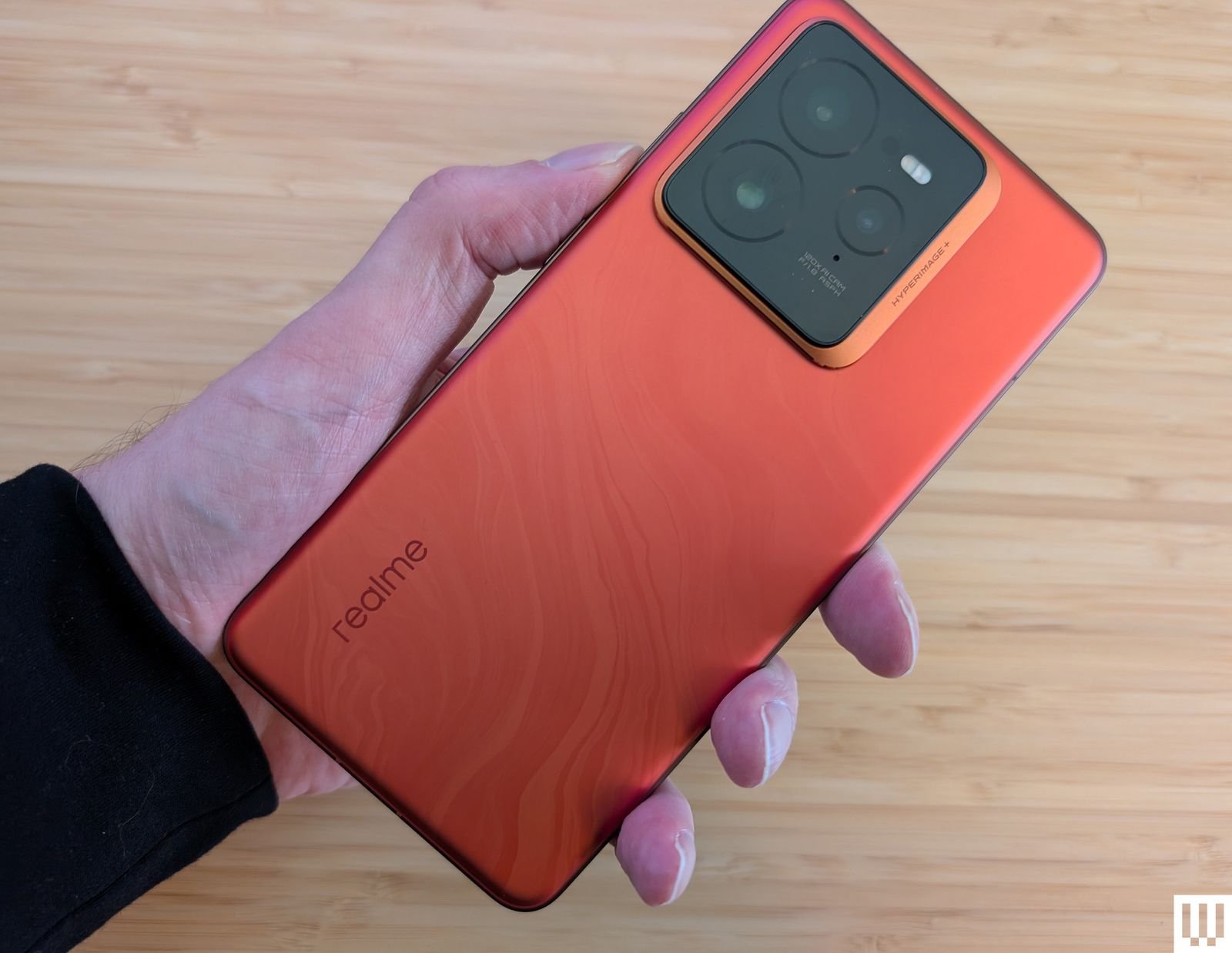 Hand of the World GT7 contract. Pro orange phone with large lenses from the camera