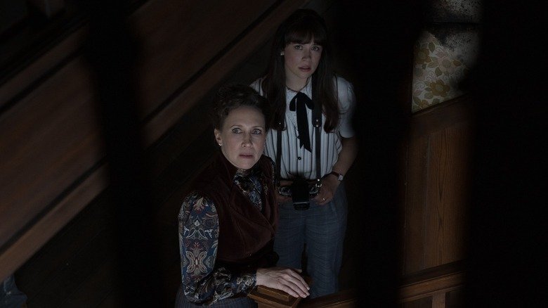 Lauren Warren Warren standing on the stairs together looking towards the camera in the dropout: the last rituals