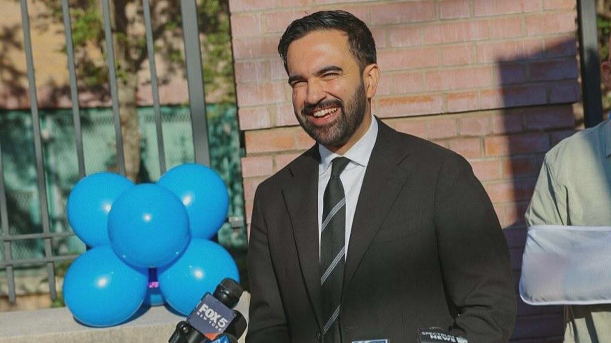 Mamdani smiles in an advertisement