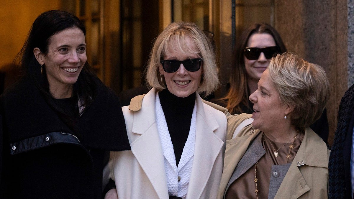 Jean Carrolls smiles outside the court