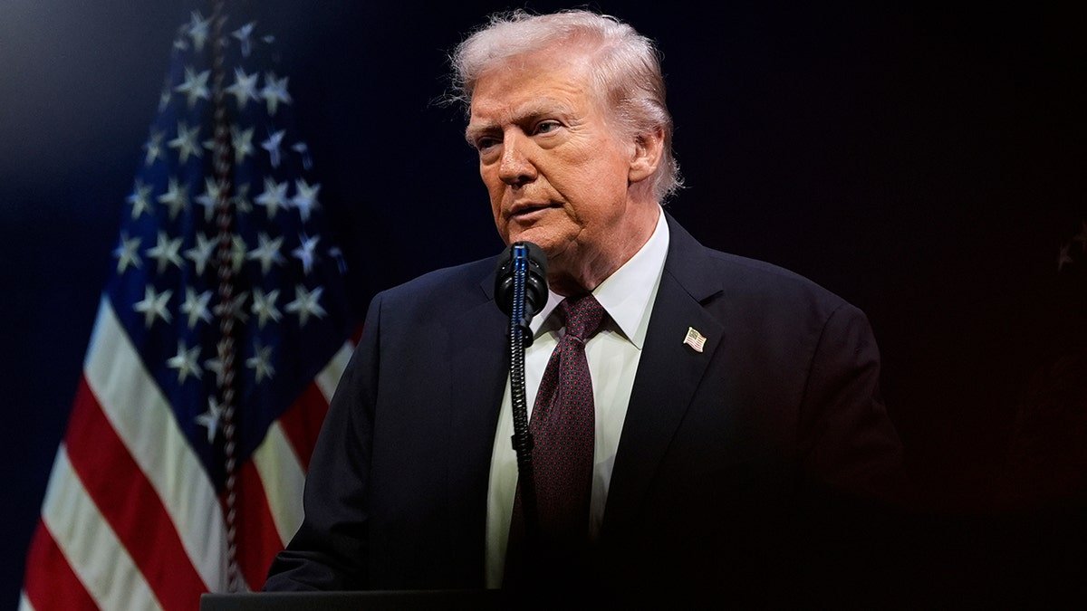 President Donald Trump speaks to the American flag
