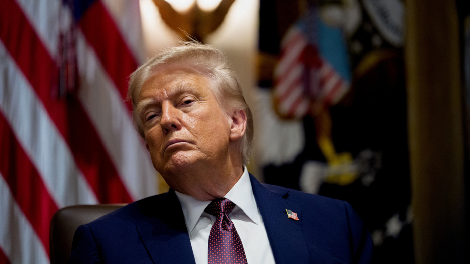 US President Donald Trump listens to the Oval Office