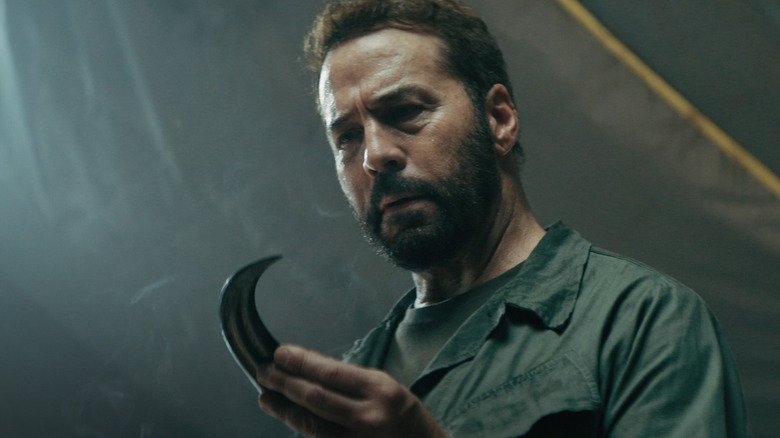 Jeremy Beven in the role of Colonel Jericho holds a Raptor claw in the primitive war