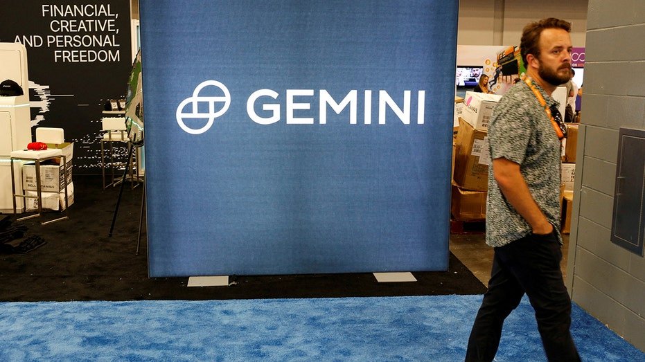 A man is going through the Greei Trust logo during the Bitcoin 2022 conference in Miami Beach, Florida, on April 6, 2022.