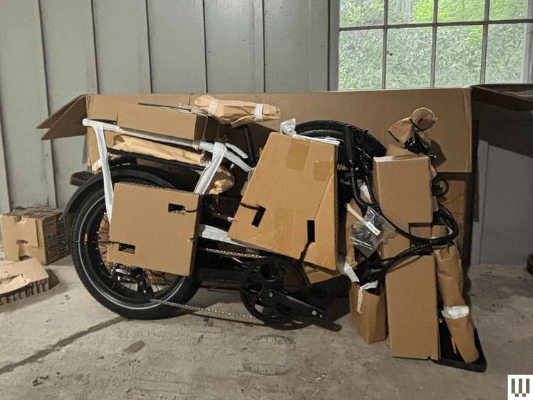 The image may contain: box, cardboard, cardboard, package, hand delivery, and person