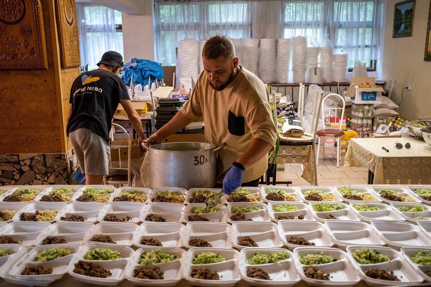 The volunteer offers food from a giant bowl on many paintings.