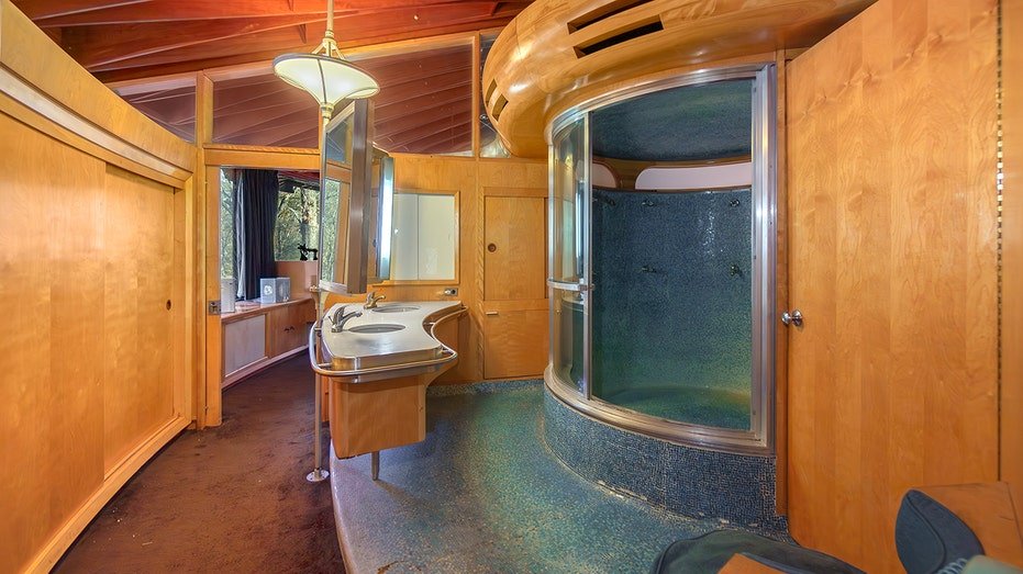 The bathroom features a curved bath.
