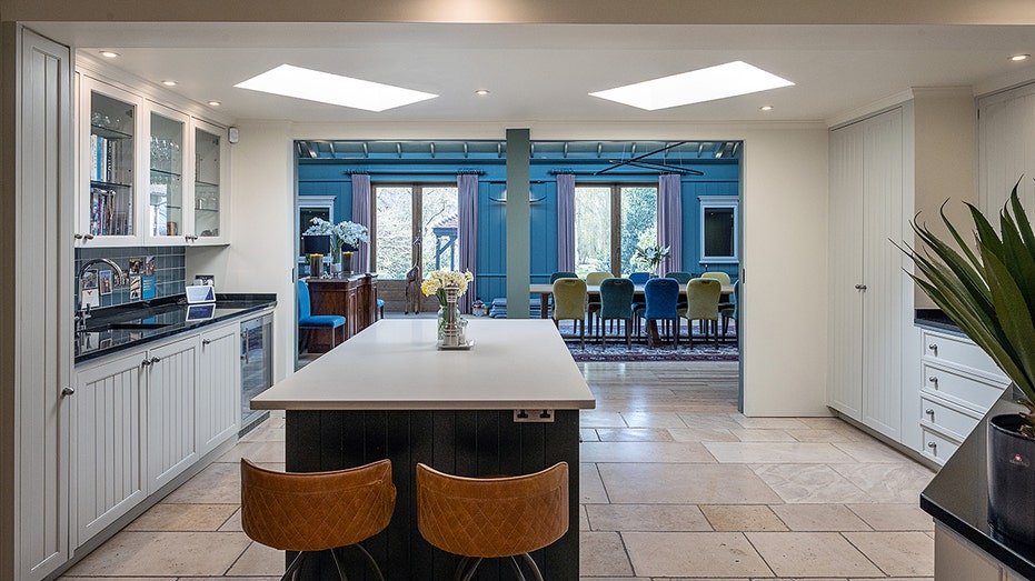 The kitchen includes a central island for dining.