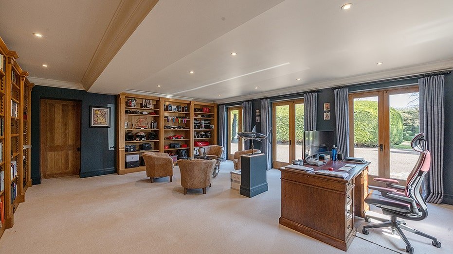 The house also includes a library with books shelves from floor to ceiling.