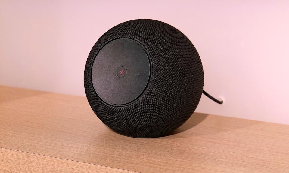 The new Amazon Echo Studio is located on a brown rack.