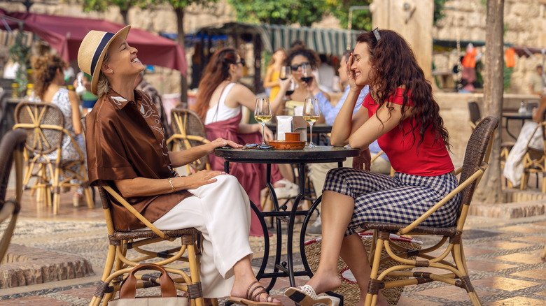 Laura and Kerry laugh at lunch outside on the girlfriend