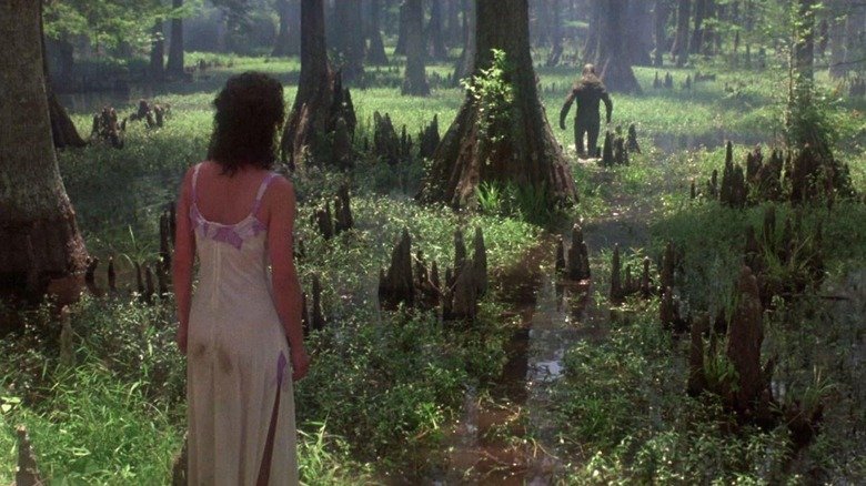 Adrian Parbo while Alice was watching a swamp walking in the swamp in Swamp Thing (1982)