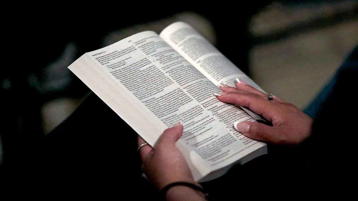 A woman reads her holy book.