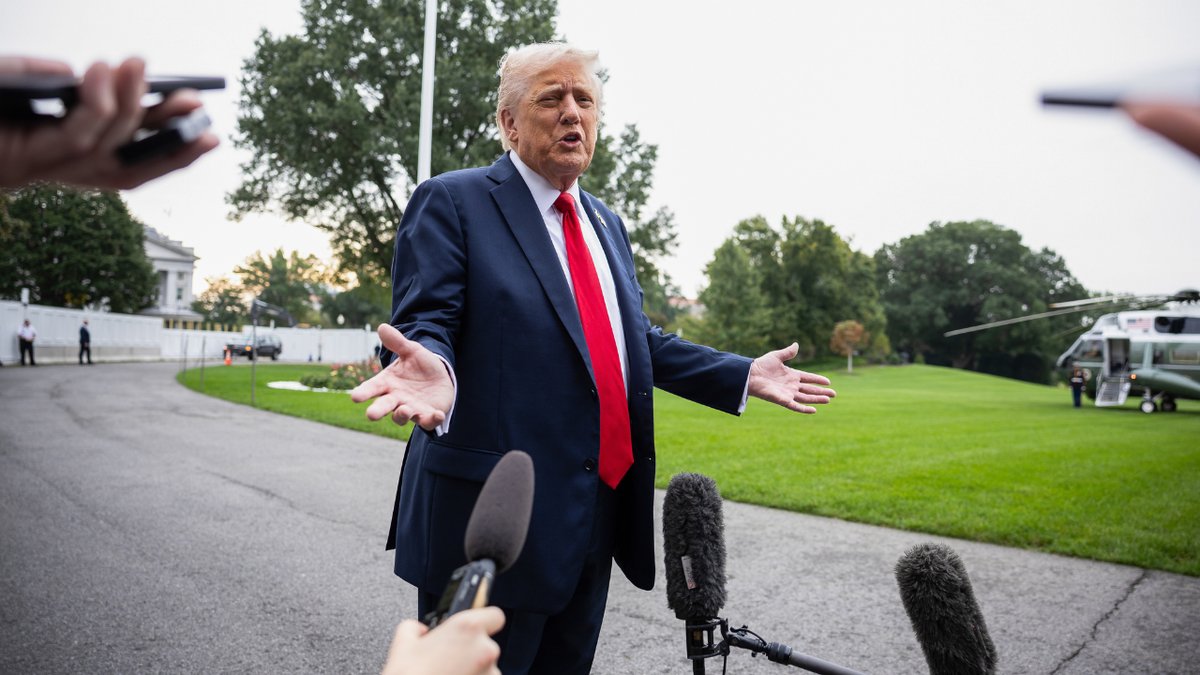 President Donald Trump speaks to media members in the southern grass of the White House