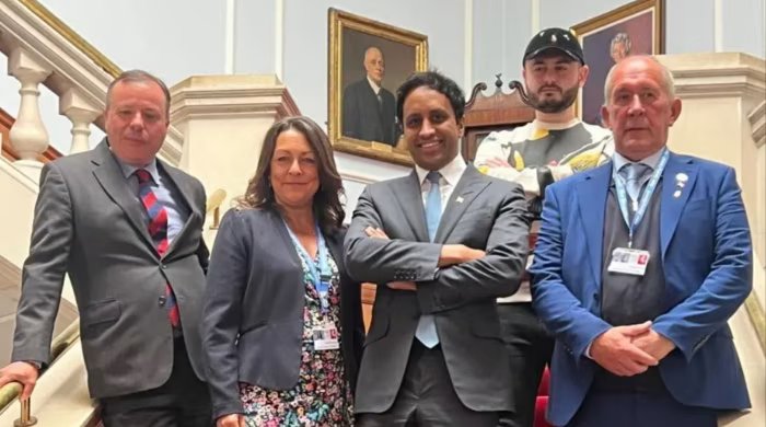 Diaa Youssef stands in the middle with Aaron Banks on the left, CLR Linden KEMKAREN, CLR BRIAN COLLINS on the right, and fetal nathani at the back on the steps in the provincial hall.